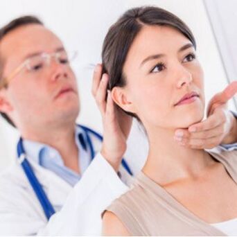 A neurologist examines a patient with neck pain